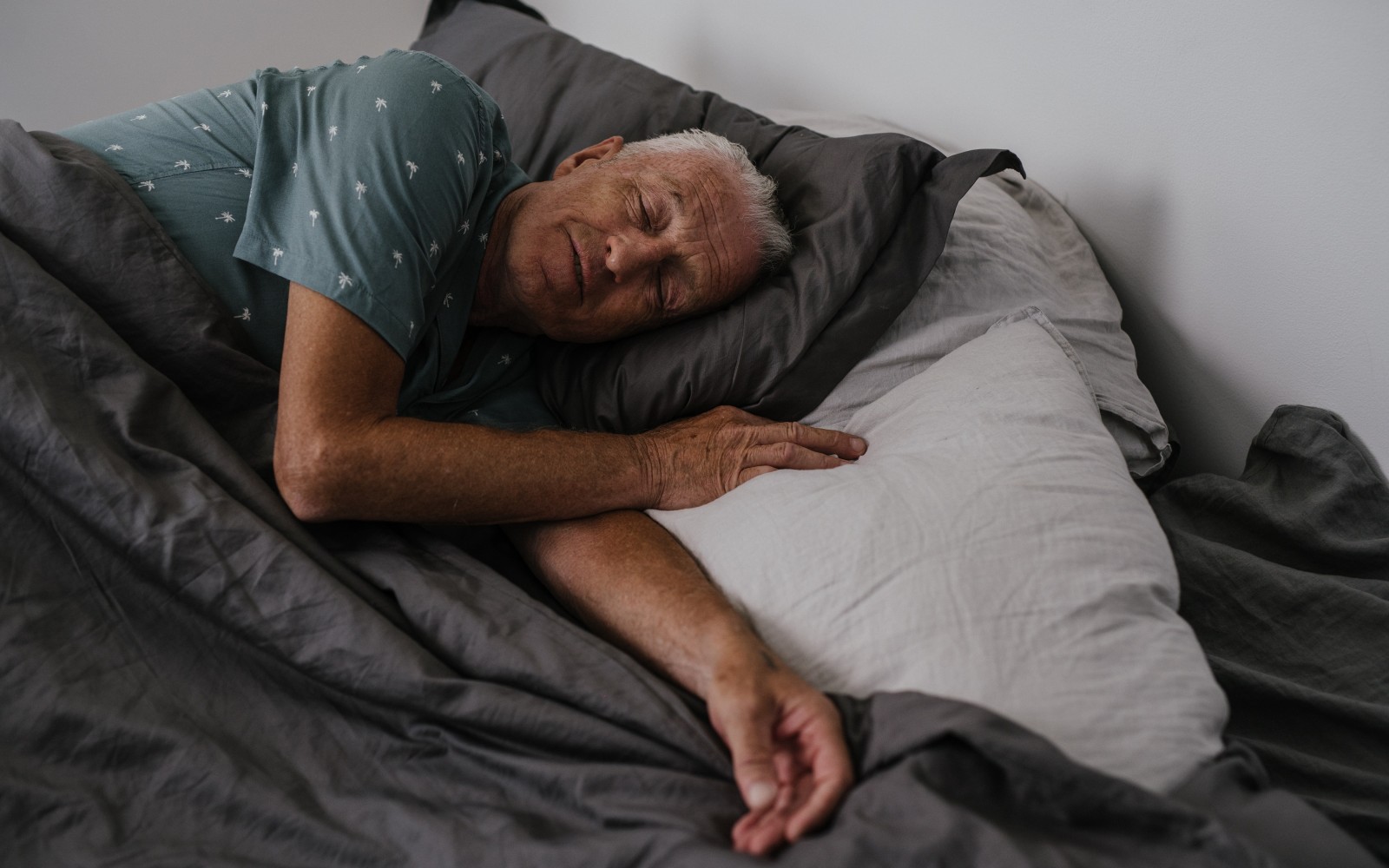 Older gentlemen asleep in bed for 'how long should you sleep for' blog 