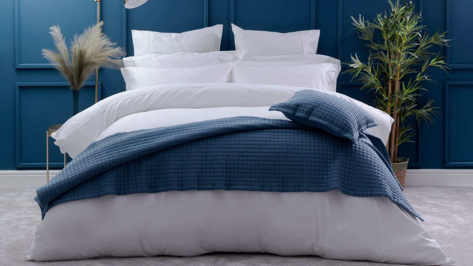 600 thread count bed sheets in pure white dressed with a blue throw available from sleep matters honley
